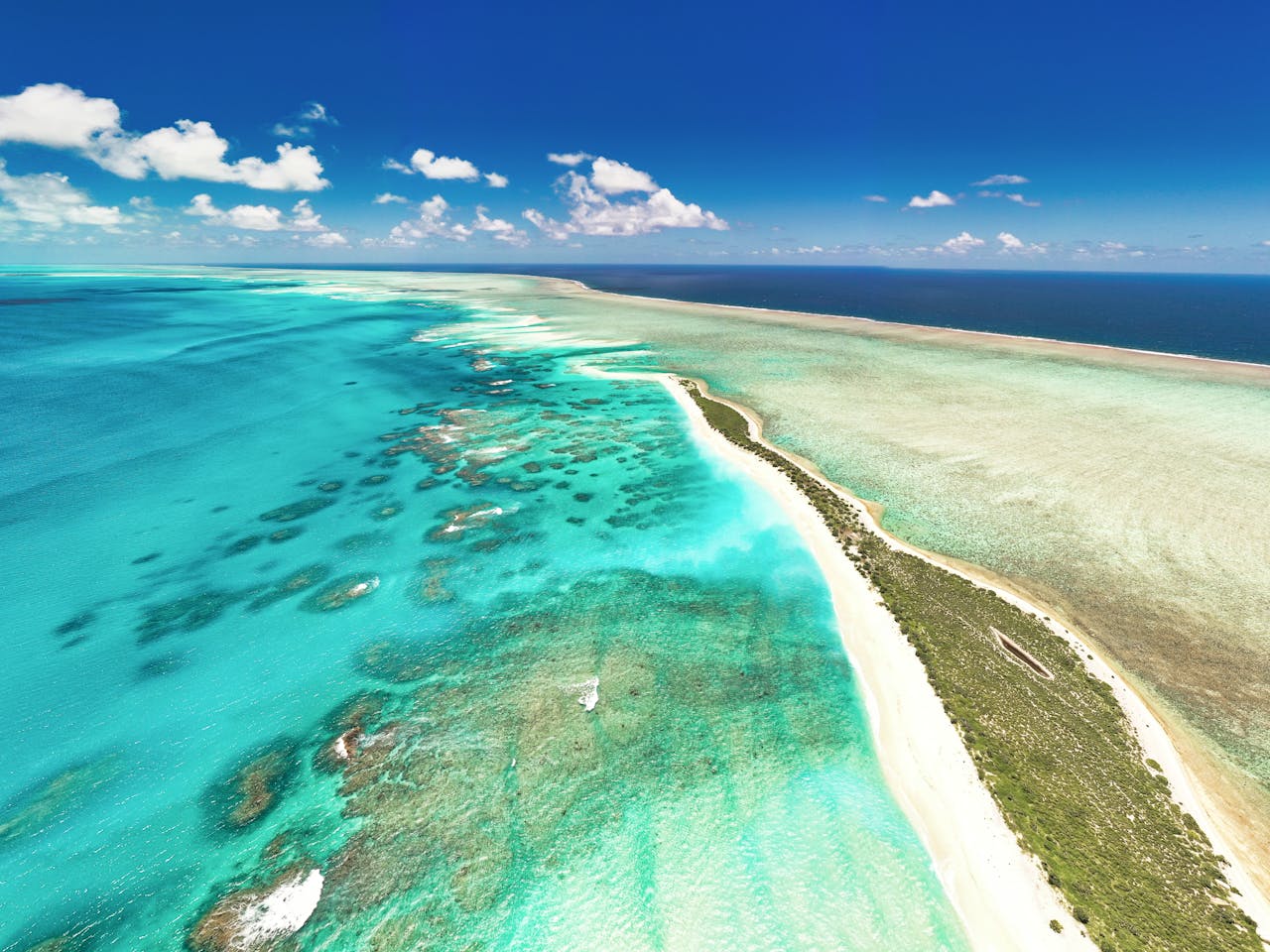 Stunning aerial shot capturing the vibrant turquoise waters and beautiful sandbars around Mauritius.